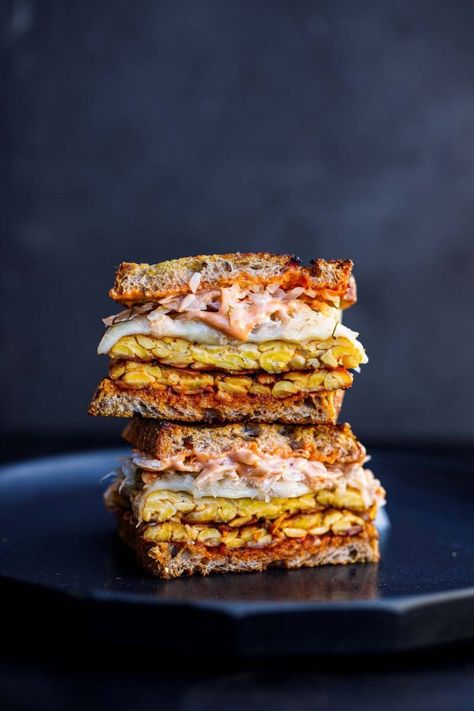 This toasty Tempeh Reuben Sandwich is so delicious! Made with seasoned tempeh, fermented sauerkraut, melty cheese, and classic Reuben sauce, keep it vegetarian or use vegan cheese for a vegan Reuben! Vegan-adaptable. Reuben Sauce, Vegan Reuben Sandwich, Tempeh Reuben, Vegan Reuben, Crispy Tempeh, Sauerkraut Sandwich, Feasting At Home, Fermented Sauerkraut, Reuben Sandwich