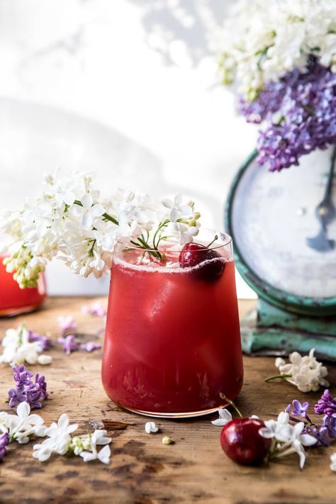 front on, close up photo Hibiscus Cherry Vodka Spritz with lilacs Summer Solstice Party, Easter Cocktails, Pitcher Drinks, Roti Bakar, Pitcher Cocktails, Solstice Party, Cherry Vodka, The Longest Day, Cocktail And Mocktail