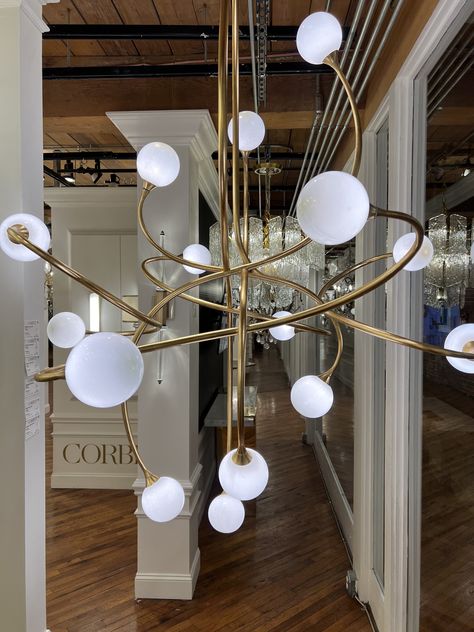 It was love at first sight when we spotted the Corbett Signature Chandelier at High Point Market! The showstopping fixture features a captivating fluid shape that keeps the eye moving. Inspired by the chaos of nature, its futuristic design is reminiscent of planets within a galaxy. #lighting #interiordesign #designinspo Futuristic Chandelier, Interior Design Hospitality, High Point Market, Globe Chandelier, Commercial Interior Design, Hospitality Design, Futuristic Design, Love At First, The Chaos