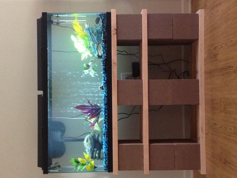 Our DIY 55gal fish tank stand.....made out of cinder blocks, wood and a little spray paint!!!!! Love love LOVE IT!!!!!! Diy Fish Tank Stand, Diy Aquarium Stand, Terrarium Stand, Aquarium Stands, Fish Stand, Fish Tank Stand, Cinder Block Garden, Diy Fish Tank, Cinder Blocks