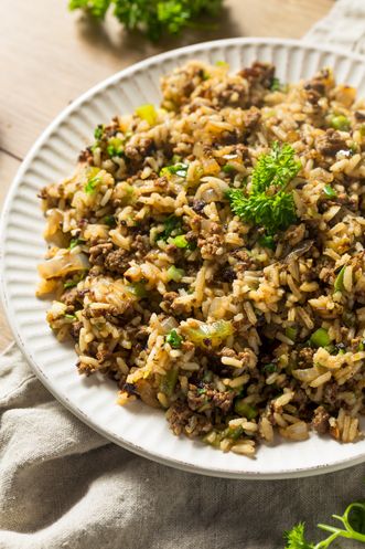 Dirty Rice is a Cajun Classic. Paula Deen's direty rice recipe uses chicken livers to give the rice its color. Can be used as a main or side dish. Pappadeaux Dirty Rice Recipe, Cajun Rice Recipe, Chicken Pilaf, Cajun Dirty Rice, Dirty Rice Recipe, Cajun Rice, Cajun Dishes, Dirty Rice, Fast Food Menu