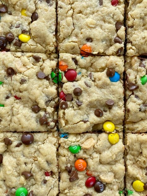 Soft-Baked Monster Cookie Bars - Together as Family Halloween Cookie Bars, Monster Cookie Bars Recipe, Leftover Halloween Candy Recipes, Monster Cookie Dough, Oats Chocolate, Monster Cookie Bars, Monster Cookies Recipe, Monster Cookie, Peanut Butter Oats