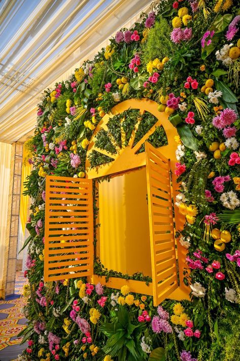 Peep out of the window hugged with deep fragrance of exotic flowers was an amazing experience for every excited guest. Haldi Selfie Booth, Selfie Point Ideas, Garden Theme Decor, Event Decor Business, Mehendi Theme, Haldi Theme, Shadi Decor, Haldi Shoot, Floral Entrance