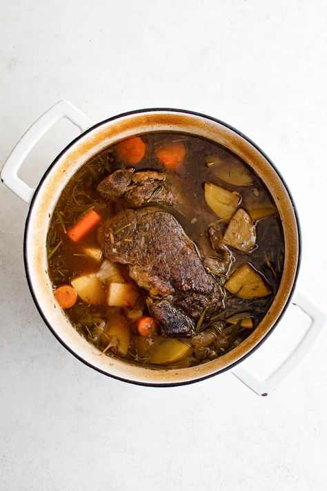 This melt-in-your-mouth Dutch Oven Pot Roast is made by slowly braising potatoes, carrots, and beef in a mouthwatering combination of red wine, fresh herbs, beef broth, and fatty beef drippings. Easy to make, this classic Sunday pot roast is a true one-pot meal and the perfect comfort food. Sunday Pot Roast, Dutch Oven Pot Roast, Oven Pot Roast, Potatoes Carrots, Dutch Oven Recipes, Pot Roast Recipes, Beef Stroganoff, Beef Broth, Oven Roast