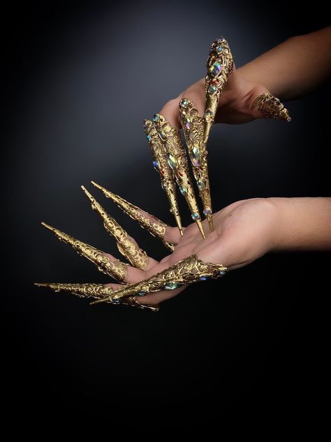 Universal claws on the fingers of gold color decorated with rhinestones. Great props for a photo shoot. You can use them for photography, makeup, or as part of a Halloween costume. Suitable for Gothic Party, Cosplay, Summer Festival, Burning Man, Halloween Party. 100% designed and handmade by our designers ( SETA Design studio in Kyiv). ...#A #Jewelry #Culture #Art #Exploring #Accessories #Fusion #the #Vibes #and #Cali #of #Unique #of #Coastal #Charm #Organizers #Creativity #StatementJewelry Finger Prosthetic, Nails Jewellery, Finger Claws, Claw Rings, Claw Jewelry, Gothic Party, Hand Decoration, Secret Garden Parties, Gothic Nails