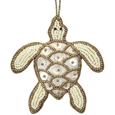 These handmade, Indian beaded, and strung natural Mother-of-Pearl Turtle ornaments will add charm and beauty to your tree! They are equally attractive to decorate a pull for your ceiling fan, window shade or light. Each ornament is carefully designed and crafted by hand. The detailed beadwork and natural shell design is duplicated on both sides of each ornament—handwork rarely seen anymore! Color: Gold | Bay Isle Home™ Hanging Figurine Ornament in Gray / Yellow, Size 4.0 H x 4.0 W x 4.0 D in | W Nautical Christmas Tree, Turtle Ornament, Nautical Christmas, Shell Design, Beaded Ornaments, Nautical Decor, Yellow And Brown, Ornament Set, Pearl Beads