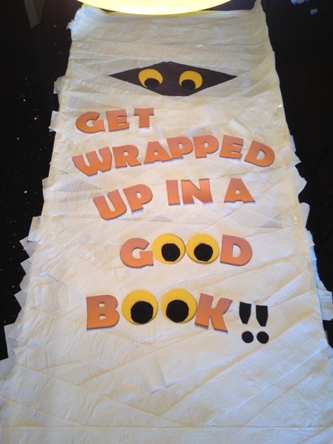 Get wrapped up in a good book- door poster for fall book fair. Fall Book Fair Ideas, Halloween Bookfair, Get Wrapped Up In A Good Book Bulletin Board, Fall Book Fair Themes, Halloween Book Fair Theme, Library Halloween Decorations, Halloween Library Bulletin Boards, Fall Into A Good Book Library Display, Halloween Book Displays Library