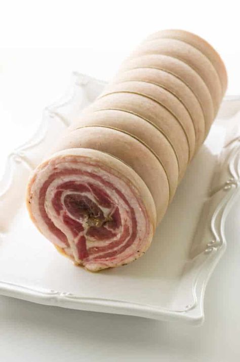 Our porchetta recipe uses a seasoned pork loin rolled inside of a slab of pork belly.  A long slow roast time renders that pork belly into an amazingly moist pork loin center with a crisp, crackling outer pork belly skin.#porchetta #dinner #holidaydinner Pork Roll Recipes, Roast Pork Belly Recipes, Rolled Pork Belly Recipes, Pork Belly Italian Recipe, Pancetta Wrapped Pork Tenderloin, Christmas Porchetta, Porchetta Recipe Italian, Pork Belly Porchetta Recipe, Porchetta Recipes