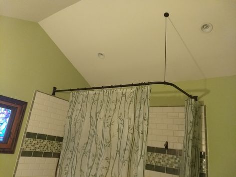 A corner shower rod with a sloped rod support on an angled ceiling. Oil Rubbed Bronze finish and rectangular flanges. All parts made from 100% brass. Corner Shower Curtain Rod, Porcelain Tub, Ceiling Curtain Track, Curved Railing, Angled Ceiling, Ceiling Curtains, Shower Rods, Beige Curtains, Cool Shower Curtains