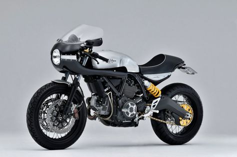 Since the introduction of the Ducati Scrambler, we’ve all seen that this was a really cool platform for building custom motorcycles. The past two years I’ve featured dozens of them. The meant-to-be-hipster-bike Ducati Scrambler (no I don’t turn the names around like the marketers intended to), is a cool bike from itself and has a … Ducati Scrambler Sixty2, Scrambler Sixty2, Ducati Scrambler Custom, Cafe Moto, Scrambler Custom, Cafe Racer Magazine, Custom Street Bikes, Bike Builder, Moto Cafe