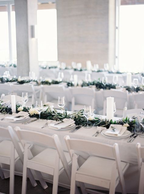 white on white wedding reception | simple white folding chairs | modern minimal wedding with rustic touches | neutral wedding | greenery garland centrepiece |  Waikopou Bay, Waiheke Island | poolside waterfront wedding ceremony Wedding Greenery Garland, Waterfront Wedding Ceremony, Wedding Reception Chairs, White Folding Chairs, Minimalist Wedding Ideas, Chairs Wedding, White Weddings Reception, Reception Chairs, White Chairs