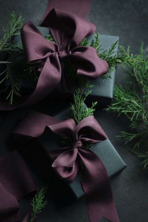 Luxury gift wrapping. Hand dyed silk ribbon and winter greens as gift toppers. Christmas gift wrapping inspiration. Elegant Christmas Gift Wrapping, Christmas Gifts Packaging, Elegant Christmas Wrapping, Luxury Gift Wrapping, Christmas Wrapping Ideas, Moody Christmas, Holidays 2023, Holiday Gift Wrapping, Elegant Gift Wrapping