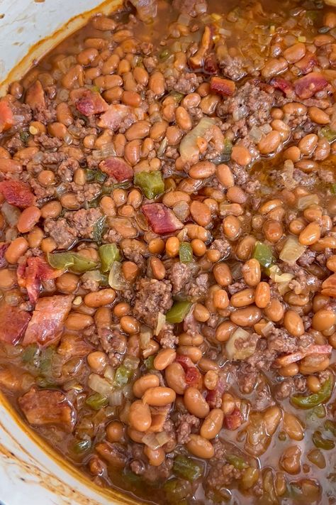 This hearty Cowboy Beans recipe is amped up baked beans with ground beef, bacon, BBQ sauce, bell pepper, and onions-- then baked until thick. It's a perfect side dish to any meal. Cowboy Beans Recipe, Baked Beans With Ground Beef, Beans With Ground Beef, Cowboy Baked Beans, Bacon Bbq Sauce, Coconut Cream Cheese, Whipped Coconut Cream, Coconut Cream Cheese Frosting, Baked Beans With Bacon