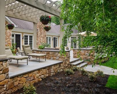 Raised Stone Patio With Wood Pergola Stone Pergola, Backyard Dining Table, Pergola Metal, Backyard Dining, Pergola Diy, Raised Patio, Patio Pergola, Stone Patio, Pergola Lighting