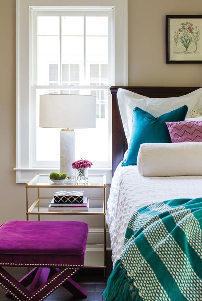 Pops of jewel tones in the master bedroom illustrate how the overall neutral palette throughout the house can become the backdrop for multiple color schemes. Terracotta Design, Dark Wood Bedroom, Dark Wood Bed, Glass Nightstand, Guest Bedroom Design, Transitional Bedroom, Marble Columns, How To Dress A Bed, Eclectic Bedroom