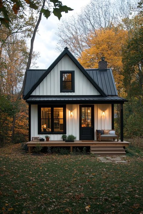 Small elongated cottage house with black and white siding metal roof small porch. Fall in love with these small but charming and cozy small houses, from cottages to modern cabins. Live tiny at large! Victorian Homes Small Tiny Cottages, Small New House, Small Tudor House Plans, Guest House 2 Bedroom, Old Small House Interior, Metal Tiny House Exterior, Simple Cabin Exterior, Tiny Home With Fireplace, Small Home With Porch