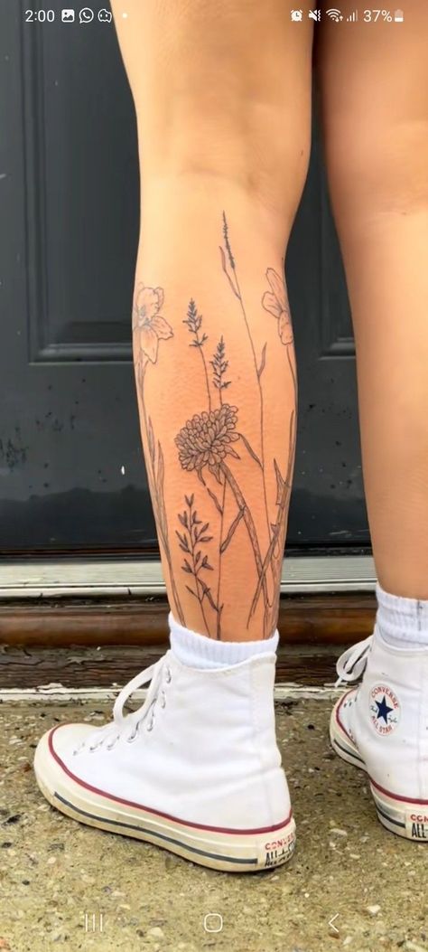 Flower Tattoo On Shin, Flower Leg Piece Tattoo, Flower Garden Tattoo Ankle, Wild Flower Calf Tattoo, Girly Thigh Tattoos Women, Flowers Calf Tattoo, Flower Wrap Leg Tattoo, Flower Around Ankle Tattoo, Flowers Around Leg Tattoo