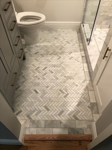 Tile bathroom floor. Marble herringbone; brass detail Herringbone Tile Floor Powder Room, Herringbone Tile Floor With Border, Gray Herringbone Bathroom Floor, Tile Baseboard Bathroom, Small Marble Herringbone Bathroom Floor, 3x12 Herringbone Tile Floor, Herringbone Tile Floor Bathroom, Herringbone Tile Bathroom Floor, Herringbone Tile Floor