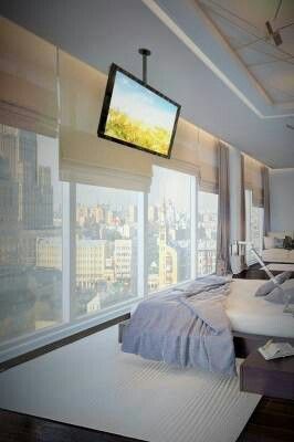 Minimal styled bedroom with city view Tv Mounted, Tv Ideas, Penthouse Living, Hidden Tv, Suport Tv, Bedroom Tv, Bedroom Closet Design, Tv In Bedroom, Condo Living