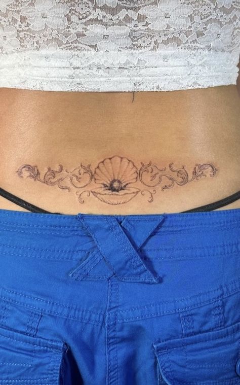 Mermaid Tattoo Placement Ideas, Wave Tramp Stamp, Cottage Core Tramp Stamp, Seashell Tramp Stamp, Pisces Inspired Tattoo, Ocean Lower Back Tattoo, Cherub Tramp Stamp, Country Aesthetic Tattoo, Dolphin Tramp Stamp