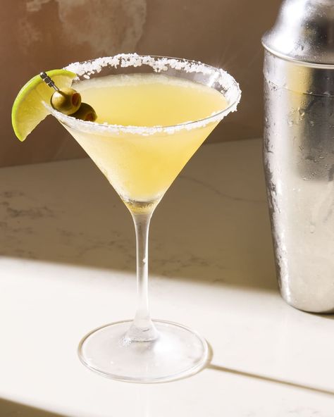 angled shot of a mexican martini in a martini glass with salted rim, and garnished with olives and a lime Mexican Martini Recipe, Texas Margarita, Tequila Martini, Mexican Tequila, Margarita Martini, Mexican Margarita, Mezcal Margarita, Olive Brine, Tequila Cocktail