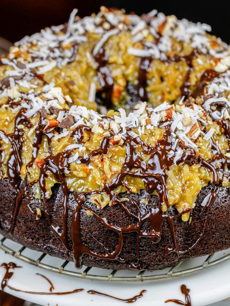 This german chocolate pound cake is made with moist chocolate cake, german chocolate cake frosting & a decadent chocolate glaze. German Chocolate Bundt Cake Easy, German Chocolate Bundt Cake Recipe, German Chocolate Pound Cake Recipes, German Pound Cake Recipe, German Chocolate Pecan Bundt Cake, Decadent German Chocolate Pecan Pound Cake Delight, Mouth Watering German Chocolate Pecan Pound Cake, German Chocolate Pecan Pound Cake, German Chocolate Pound Cake