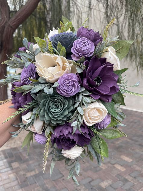 Katie 3/25/23 - Wood Flower Custom Wedding Quote in Shades of Purple, Sage Colors, Succulent center, White Anemones and Plum Purple Peonies, Dusty Miller Greenery, (1) Bride 11x14" Cascade Bouquet $329 (1) Groom Boutonniere $FREE (6) Matching 10" Bridesmaids $1,170.00 ($199 ea/discounted to $195 ea.) (6) Matching Boutonnieres $192 (33.99-38.99 ea/discounted to $32 ea.) (1) Consultation/Quote prep $ FREE TOTAL PACKAGE PRICE ~ $1,691.00 *FREE Standard Shipping (Unless Specialty or Expedited) *Your Plum And Hunter Green Wedding, Sage And Purple Wedding Decor, Dark Green And Purple Wedding, Sage Green And Purple Wedding, Purple Wedding Flower Arrangements, Purple Dahlia Bouquet, Purple And Green Wedding Cake, Lavender Color Flowers, Shades Of Purple Wedding