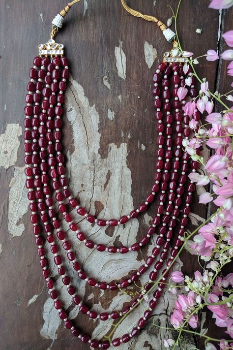 22kt gold plated 5 line mala beaded with pearls and maroon ruby beads.
Type: Ruby Beads and Pearls
Composition: Silver + Copper Mix
Color: Maroon
Other Details: 
Dimensions L x W (in cms): 30 x 4
Closure: Pull out drawcord
 - Aza Fashions Pearl Mala Designs, Terracotta Jewellery Designs, Diy Bag Designs, Terracotta Jewellery, Bag Designs, Ruby Beads, Beads Jewellery, Mix Color, Mala Beads