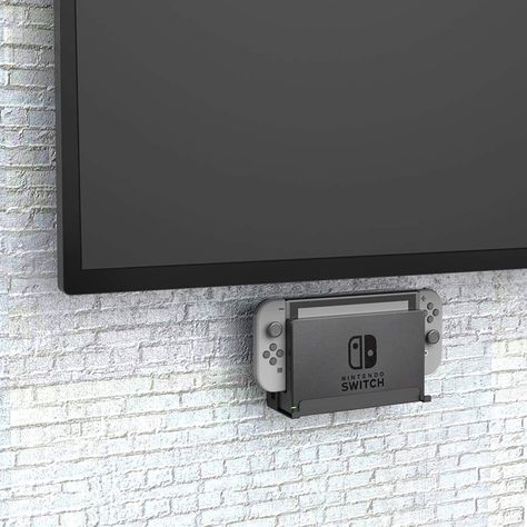 Mount your Nintendo Switch like art with Monzlteck's Wall Mount. It's sleek, sturdy, and holds your console securely. With easy installation, this minimalist mount frees up space and keeps your console safe. Show off your gaming setup in style. Game Console Organization, Shelf Holders, Console Organization, Video Wall, Wall Organization, Hanging Hooks, Gaming Setup, Tv Wall, Display Boxes