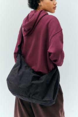 Head out for the weekend with all of your must-haves in an oversized crescent bag by BAGGU. Crafted from durable nylon Ft. a zip-up single compartment with a logo-branded webbing strap and two interior zip pockets. **Content + Care** \- 100% Nylon \- Spot clean **Size** \- 26.7cm × 49.5cm × 13.3cm \- Strap length: 95cm | BAGGU Black Large Nylon Crescent Bag - Black at Urban Outfitters Crescent Bag Outfit, Crescent Bag, Bag Outfit, 2024 Style, Everyday Fashion Outfits, Webbing Strap, Classic Boots, Classic Mini, Womens Purses