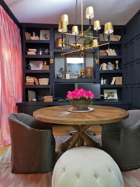 Home office features a wall of navy built-in shelves over a navy built-in desk facing a round trestle table lined with gray slipcovered chairs illuminates by a Jonathan Adler Ventana 2 Tier Chandelier atop a pink herringbone rug across from pink silk curtains. Reading Room Design, Piano Library, Glam Dining Room, Home Library Decor, New York Brownstone, Genevieve Gorder, Asian Homes, Library Decor, Romantic Homes