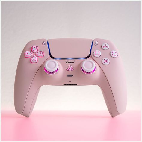 [AffiliateLink] Pink And Stunning, This Ps5 Controller Is Customized To Perfection. Fitted With A Light Sakura Pink Shell, It Boasts An Led Mod That Illuminates Its White Buttons And Analogue Sticks, Making It A Showstopper In Your Hands And A Stunning Piece Of Gaming Hardware As It Rests Next To Your Ps5. Your Gaming Setup Will Never Be The Same.When A Gaming Controller Is Engineered Pretty Much To Perfection Like The Ps5, You Really Wonder What Is Left For Us #pinkgamingsetup Pink Ps5, Pink Games, Ps5 Controller, Gamer Setup, Gaming Controller, Gaming Room Setup, Gamer Room, Pc Setup, Pink Girly Things