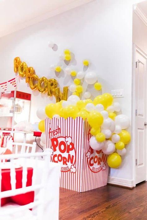 20 Super Fun Movie Night Party Ideas - Lady Celebrations Popcorn Party Ideas Decoration, Carnival Birthday Party Balloons, Diy Popcorn Box With Balloons, Popcorn Birthday Party Theme, Popcorn Boxes Ideas, Popcorn Theme Party Decoration, Diy Giant Popcorn Bucket, Popcorn Balloons Decoration, Diy Popcorn Decorations