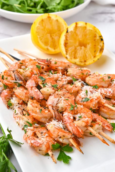 Looking for a delicious and easy-to-make recipe for your next summer BBQ? Try these mouth-watering lemon garlic parmesan shrimp skewers! Made with succulent shrimp, zesty lemon, aromatic garlic, and savory parmesan cheese, these marinaded shrimp skewers are sure to be a hit with your guests. Plus, they're a great source of protein and Omega-3s. Get the recipe now and impress your friends and family with your culinary skills! Garlic Shrimp Skewers, Skewers On The Grill, Grill Foods, Parmesan Shrimp, Garlic Parmesan Shrimp, Spot Prawns, Lemon Garlic Sauce, Grilled Shrimp Skewers, Lemon Garlic Shrimp