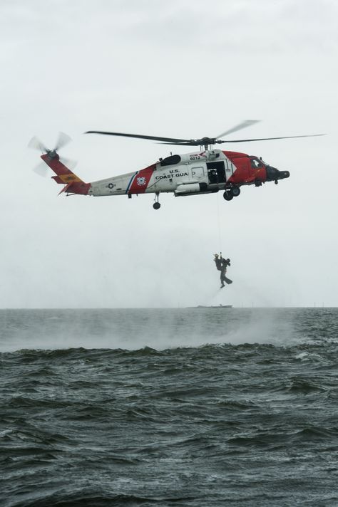 Rescue swimmer,from Coast Guard Air Station Elizabeth City,North Carolina,lifts Capt. Alex Arbuckle,334th Fighter Squadron pilot,out of water into HH-60J Jayhawk during search & rescue training mission,Sept.24,2015,off coast of North Carolina.Airmen from Seymour Johnson AFB,North Carolina & sailors from Coast Guard Air Station Elizabeth City & Coast Guard Station Hobucken,North Carolina worked together to locate & rescue simulated ejected pilot & weapons systems officer as part of training ex. Coast Guard Wallpaper Iphone, Rescue Swimmer Coast Guard, Uscg Rescue Swimmer, Coast Guard Aesthetic, Coast Guard Rescue Swimmer, Elizabeth City North Carolina, Rescue Swimmer, Coast Gaurd, Coast Guard Helicopter