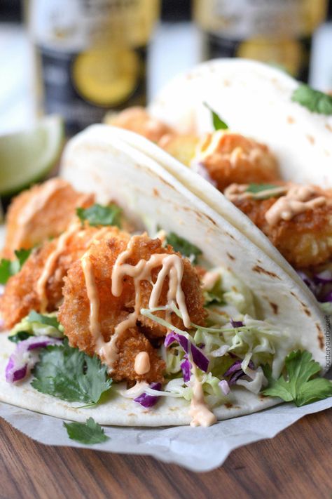 These Crispy Shrimp Tacos with Cilantro Lime Slaw will seriously rock your world! A quick and easy weeknight meal that is sure to become a family favorite. Crispy Shrimp Tacos, Hot Garlic Sauce, Cilantro Tacos, Shrimp Tacos Easy, Lime Slaw, Spicy Shrimp Tacos, Cilantro Lime Slaw, Shrimp Taco Recipes, Breaded Shrimp