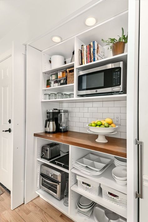 Coffee Bar & Appliance Closet – An old hallway closet is now a coffee bar with a butcherblock countertop. The microwave, toaster, and toaster oven remain hidden off the main kitchen counters. The retractable pocket doors can remain open while entertaining. Grab a cup of coffee! Appliance Closet, Appliance Storage, Pantry Remodel, Countertop Appliances, Home Coffee Bar, Kitchen Pantry Design, Closet Kitchen, All White Kitchen, Pantry Design