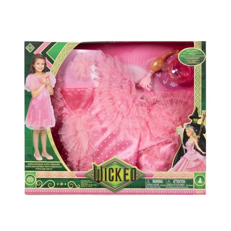 Fans of Universal Pictures’ Wicked will love playing dress up with this fun look inspired by one of Glinda’s most exciting songs! Act out one of your favorite scenes as Glinda, while dressed in this nightgown style “Popular” dress with layers and pinwheels of ruffles. Deluxe Dress Up Set includes 1 pink “Popular” dress with gathered sleeves and ruffles. Comes with 2 accessories - use Glinda’s Perfume Bottle and Rosette Hairclip to finish your popular style! Only available at TARGET. Wicked Merch 2024, Glinda Popular, Wicked Merch, Dream Daughter, Dress With Layers, Popular Dress, Wicked Movie, Toys Land, The Wonderful Wizard Of Oz