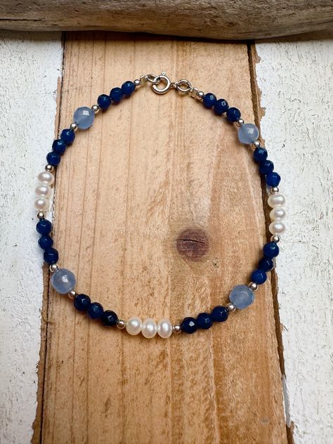 This is a lovely handmade beaded gemstone bracelet. This bracelet is made using light blue agate and dark blue agate, as well as freshwater pearls.  This bracelet has a sterling silver clasp as well. This bracelet has a length of approximately 19cm. It is the perfect bracelet for stacking.  If you love this and feel the price is a little out of reach, please pop me a message and we can sort something out. Agate Beaded Bracelets, Stone Bead Jewelry, Summer Jewellery, Blue Beaded Bracelets, Bracelets Design, Diy Bracelets Patterns, Diy Bracelet Designs, Jewelry Making Project, Bracelet Blue