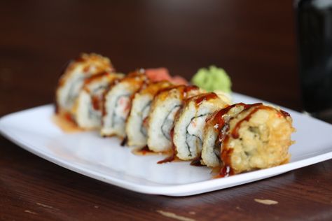 Our infamous Crab Rangoon Roll. Cream cheese, crab and scallion rolled in sushi rice and tempura-fried, topped with teriyaki and sweet chili sauce. #crabrangoonroll #sushi #friedfood #bestsushiever Crab Rangoon Sushi Roll, Crab Rangoon Sushi Roll Recipe, Crab And Cream Cheese, Sushi Bazooka, Sushi Roll Recipes, Sushi At Home, Cheese Roll, Sushi Love, Sushi Sushi