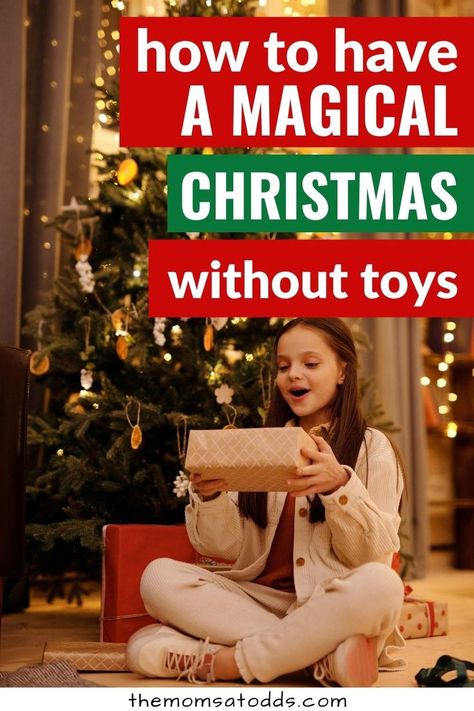 How to have a magical Christmas without toys. Photo of child sitting under Christmas tree with a gift. Magical Christmas For Kids, Christmas Presents For Toddlers, Make Christmas Magical, Non Toy Gifts, Gift Ideas For Kids, Christmas Traditions Family, Christmas Surprise, Toy Gifts, Christmas Activities For Kids