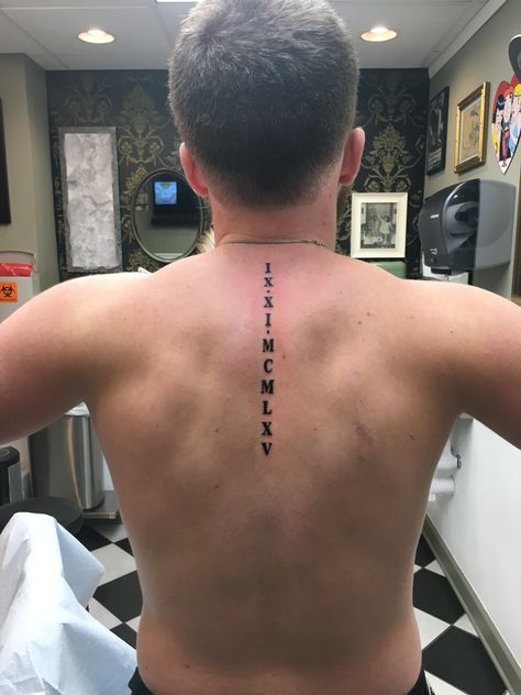 Roman Numeral Spine Tattoo Man Spine Tattoo, Vertical Roman Numeral Tattoo, Roman Numeral Leg Tattoo, Tatoos Men Back Spine Tattoos, Roman Numeral Spine Tattoo, Male Spine Tattoos, Spinal Tattoo For Men, Roman Numeral Birthday Tattoo, Spine Tattoo Men