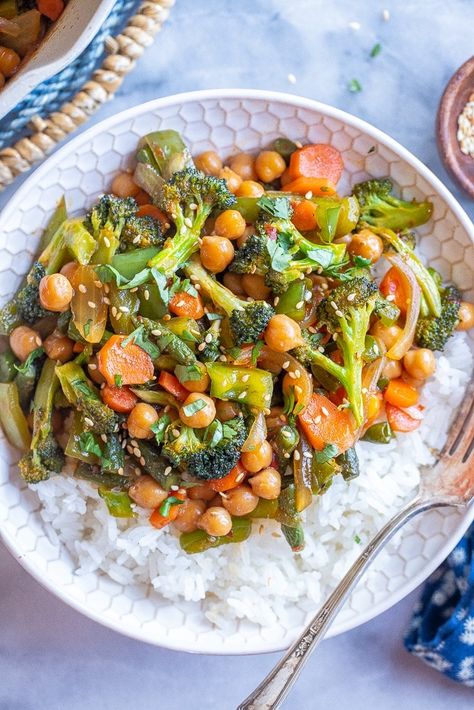 This Chili Garlic Vegetable Stir Fry with Chickpeas comes together in just 30 minutes and in one pan! It's easy to make, but big on flavor and is great when you have lots of vegetables in the refrigerator that need to be used up. Serve with rice or noodles and enjoy for lunches throughout the week, or a delicious weeknight dinner. #stirfryrecipe #veggiestirfry #chiligarlicsauce #vegan #weeknightdinner Chickpea Stir Fry, Chili Garlic Sauce, Chickpea Recipes, Veggie Stir Fry, Vegetable Stir Fry, Stir Fry Recipes, One Pan, Chickpeas, Rice Recipes