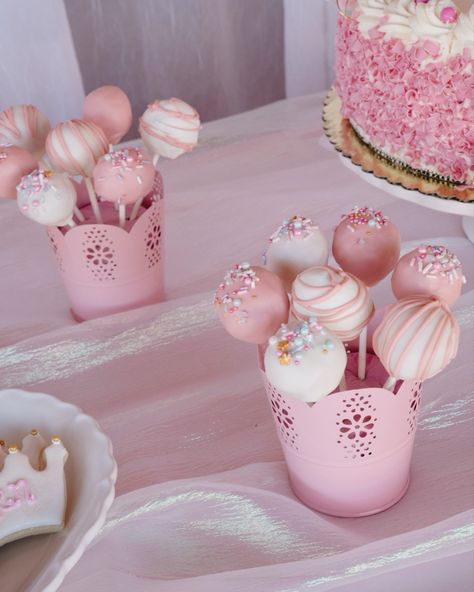 White and pink Cake pops on a dessert table in pink meta containers. Blush Cake Pops, Girly Cake Pops Birthday, Pink And Blue Cake Pops, Blush Pink Cake Pops, White Cake Pops With Pink Sprinkles, Pink Candy Buffet, Cake Pop Bouquet, Baby Shower Party Themes, Baby Shower Cake Pops