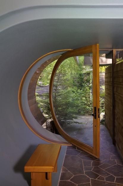 A lover of music, the client wanted a house that not only became part of the natural landscape but also addressed the flow of music. Hobbit Door, Casa Hobbit, Cool Doors, Pivot Doors, Hobbit House, Open Door, Studio Mcgee, Unique Doors, Beautiful Doors