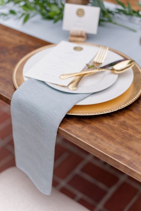 Steel Blue And Gold Wedding, Dusty Blue Wedding Place Setting, Light Blue And Gold Table Setting, Dusty Blue And Gold Wedding Theme, Blue Napkins Table Setting, Gold Chargers Place Setting, Gold Place Setting Wedding, Blue And Gold Place Setting, Dusty Blue Plate Setting