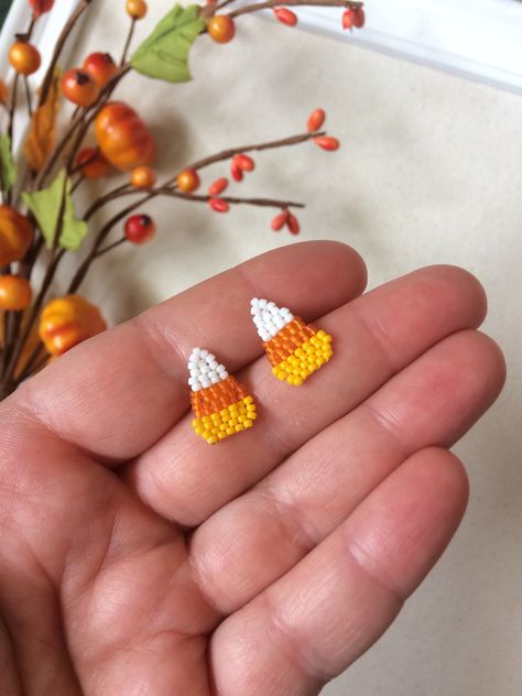 These adorable candy corn earrings are a great way to bring in the October month with.  Very light weight and cute jewelry for that Halloween fun feel.  These are sewn on studs.  No glue was used for making these earrings for those with adhesive allergies. Easy Halloween Earrings, Beading Patterns Earrings, Halloween Diy Earrings, Beaded Earrings Halloween, Beaded Halloween Jewelry, Beaded Fall Earrings, Beaded Stud Earrings, Diy Halloween Earrings, Cute Handmade Halloween Earrings