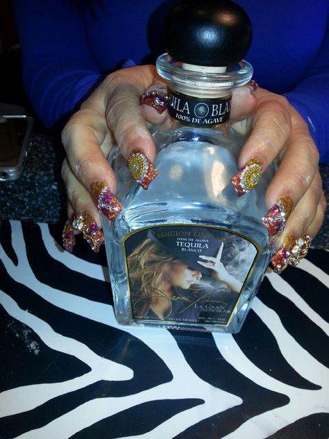 Jenni Rivera ; my mom showing off her new nails and her new tequila bottle of la diva de la Banda ! <3 Tequila Bottle, Latin Artists, Jenni Rivera, Tequila Bottles, Mom Show, School Dropout, New Nails, Charity Work, Grammy Nominations