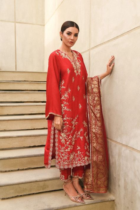 Adorned on pure raw silk 80 gms, in a deep pomegranate hue intricately embellished with single thread zari and sequins. The length of the long kameez is 48 inches. Styled with zari trousers and a pure organza matching dupatta featuring Agha Noor’s signature hand blocked borders with gotah. An alluring three piece with Batik Print Dress, Indian Suit, Lehenga Style, Linen Collection, Embroidered Chiffon, Red Chiffon, Silk Trousers, Dyed Linen, Batik Dress