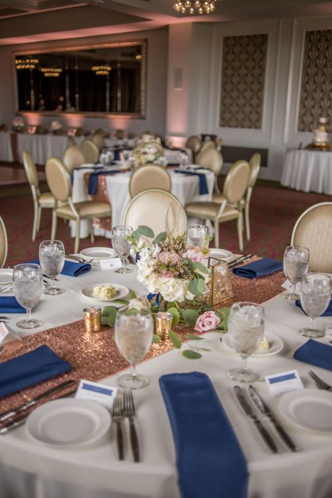 Rose Gold and Navy Wedding Reception Decor with Low Blush Rose Centerpiece with Greenery, Navy Napkins, Blue and White Printed Placecards, and Sequined Table Runners | Tampa Bay Signature Event Rentals | St Pete Wedding Venue The Birchwood | Special Moments Event Planning Blush Rose Centerpiece, Navy Wedding Reception, Centerpiece With Greenery, Gold And Navy Wedding, Rose Gold Wedding Table, Wedding Decorations Table Settings, Navy Table, Rose Gold Wedding Decor, Rose Centerpiece